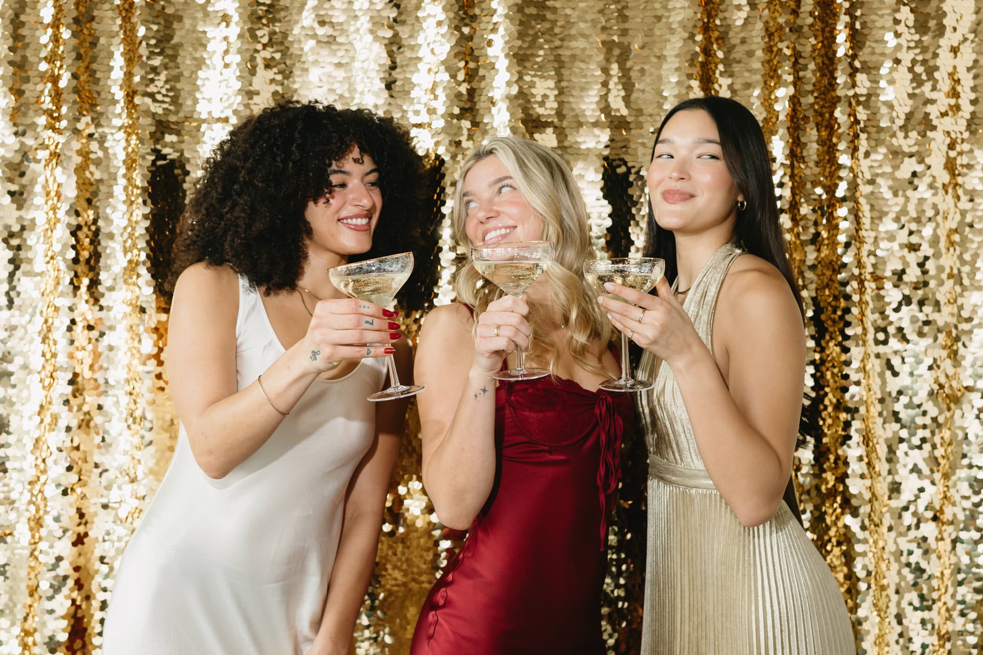 Friends celebrating with champagne at a photo booth